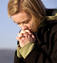 Young woman in prayer for eating disorder recovery