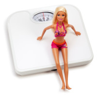 Barbie sitting on a scale