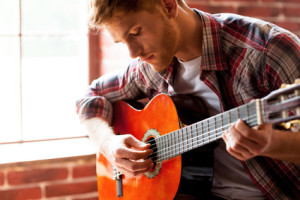 Handsome man playing guitar.