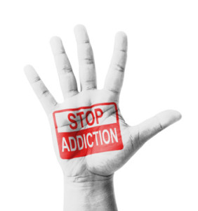 Open hand raised, Stop Addiction sign painted