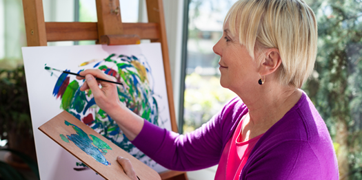 Happy Middle-Aged Woman Painting