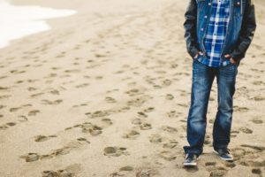 College student walking on beach