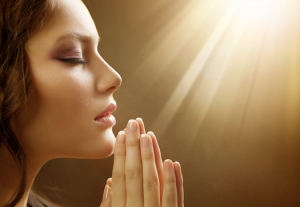 Young Woman Praying and using Spirituality in ed recovery
