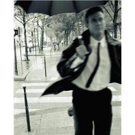 Man in suit running with umbrella
