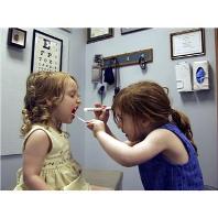 Two Children in an exam room playing doctor
