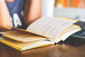 woman reading a notebook