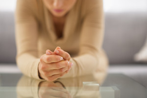 Closeup on hands of stressed young housewife