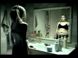 Woman looking at her body weight in the mirror not seeing Anorexia Symptoms