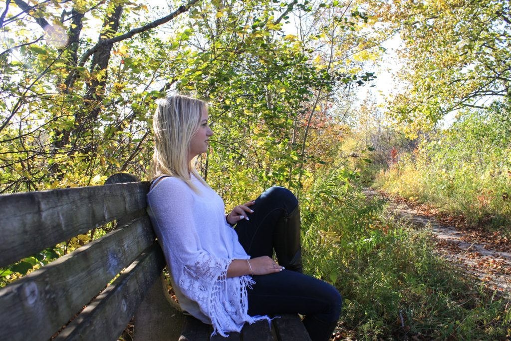 Woman sitting on bench struggling with co-occurring disorders