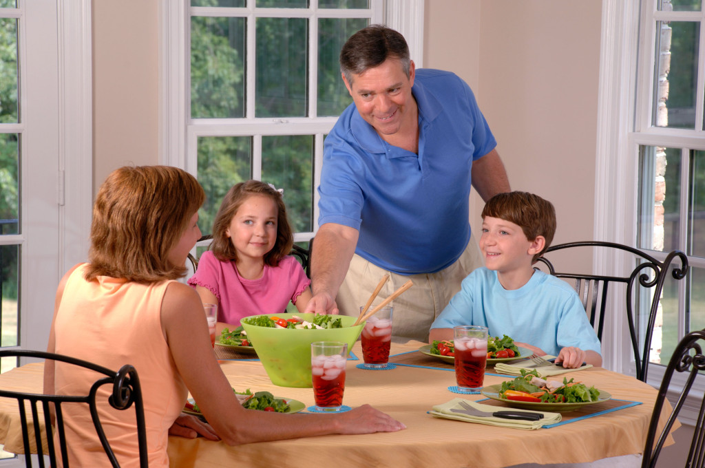 Family sitting down for dinner with new meal plan