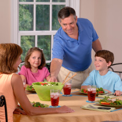 Family sitting down for dinner with new meal plan
