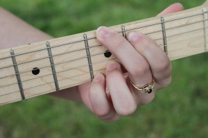 Woman with eating disorder playing guitar