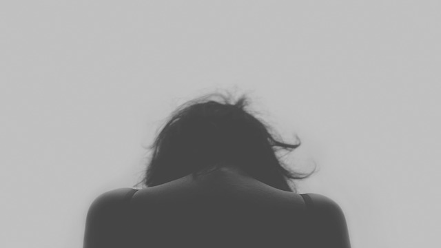 Picture of a Lady's back who is sad