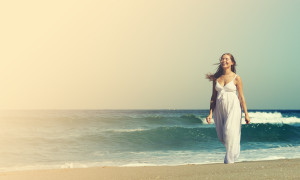 beautiful pregnant woman standing on the beach. Photo in old ima