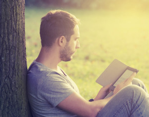 Young man reading e-book