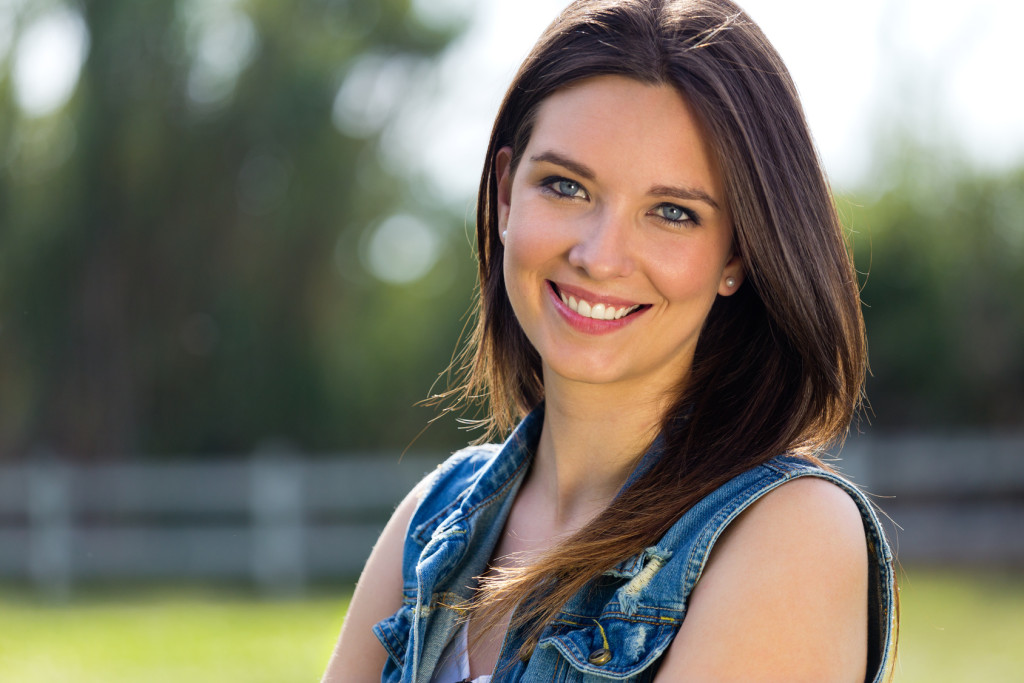 Outdoors closeup portrait of smiling woman.