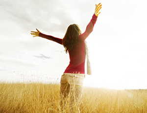 Young girl spreading hands toward God