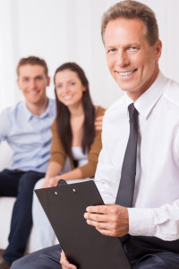 Therapist discussing the patients functional assessment with the husband and wife.