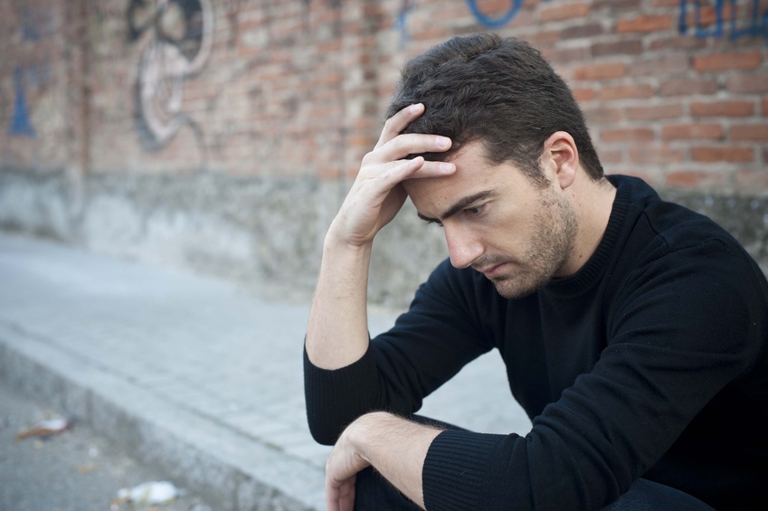 Middle-aged man with hand on his head stressing over his recently diagnosed eating disorder