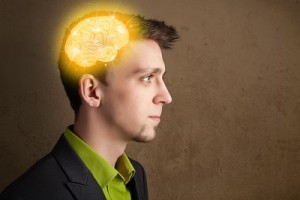 Young man thinking with glowing brain illustration