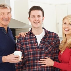 Portrait Of A Stronger Family With Adult Son At Home