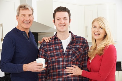 Portrait Of A Stronger Family With Adult Son At Home