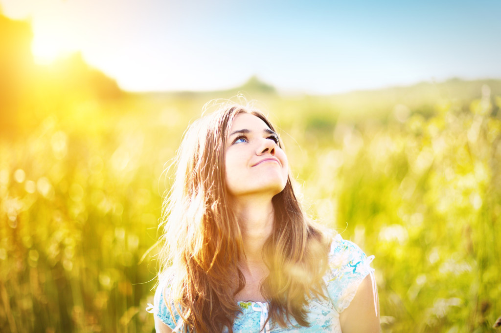 Young woman smiling in sunlight