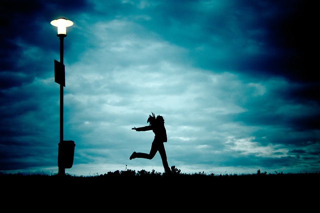 Girl jumping in clouds