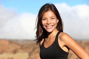 Young woman working out with a big smile