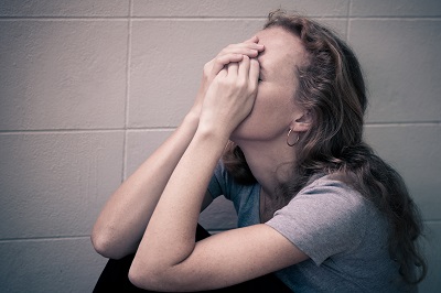 one sad woman sitting on the floor with social anxiety