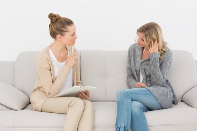 Dietician speaking with patient on the couch