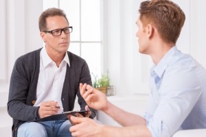 Guy talking to a therapist about males and eating disorders