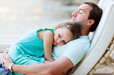 Happy father and his adopted daughter outdoors