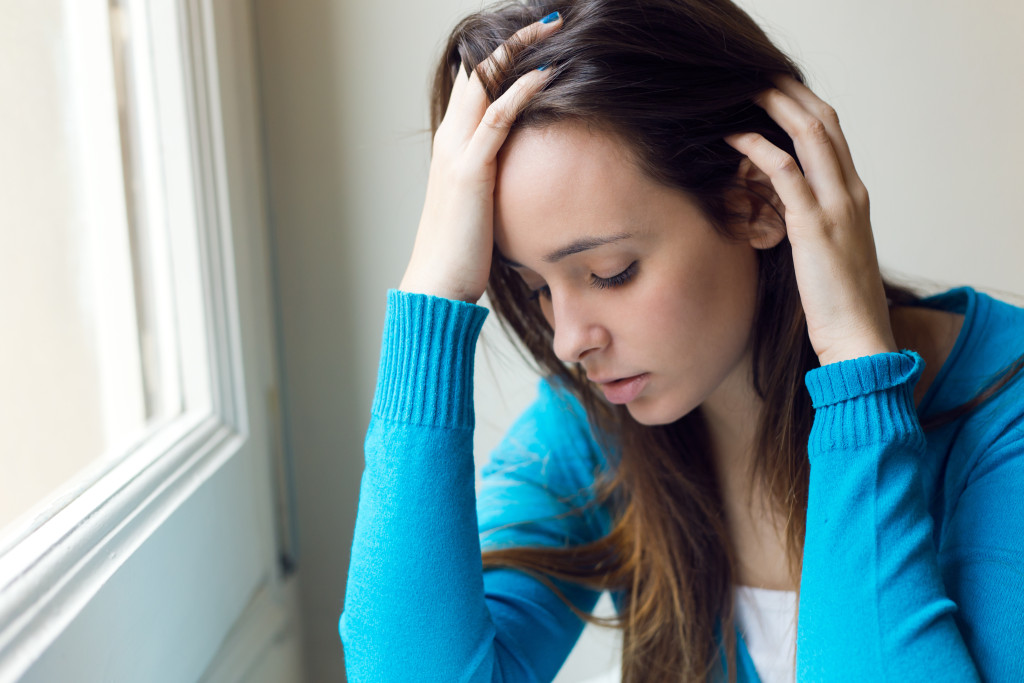 Depressed young woman thinking about Genetics and Depression