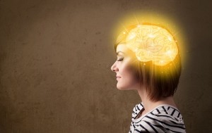 Young girl thinking with glowing brain illustration