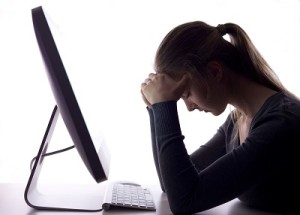 A lady at a computer struggling with bulimia in the workplace.