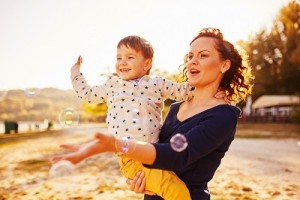 Mom and son having fun by the lake