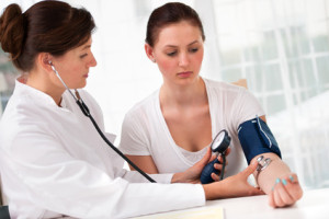 woman-doctor-and-patient-blood-pressure