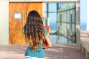 Back view of an Australian college student walking to class