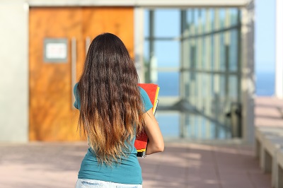 Adolescent Girl with school books