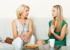 Mature woman with daughter having serious conversation