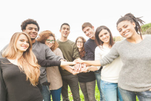 Group of friends with Hands in Stack supporting each other.