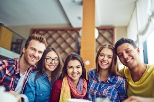 Five happy friends relaxing away from school