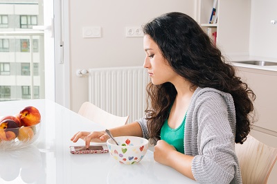 Young woman eating breakfast