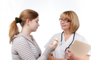 Doctor providing girl with a new prescription.