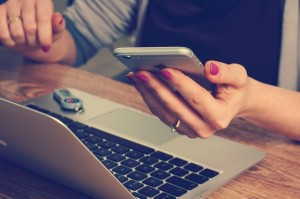 Student looking at cell phone trying to cope with social anxiety