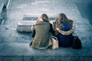 Two ladies talking in gray area