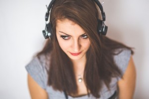Girl in iGEN listening to music to distract from anxiety