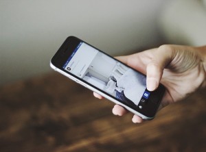 Man checking social media on his smart phone