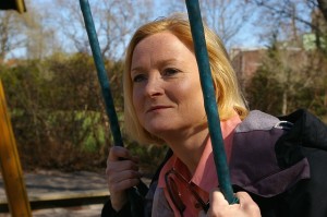 middle-aged woman sitting on swing